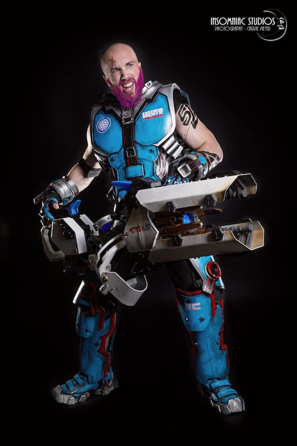 A Bald And Bearded Male Version of Zarya from Overwatch Cosplay