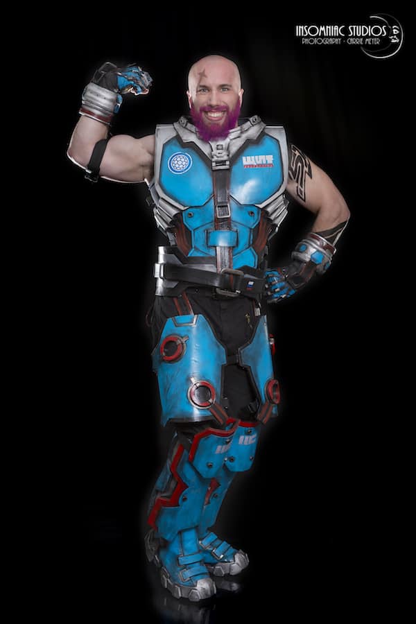 A Bald And Bearded Male Version of Zarya from Overwatch Cosplay