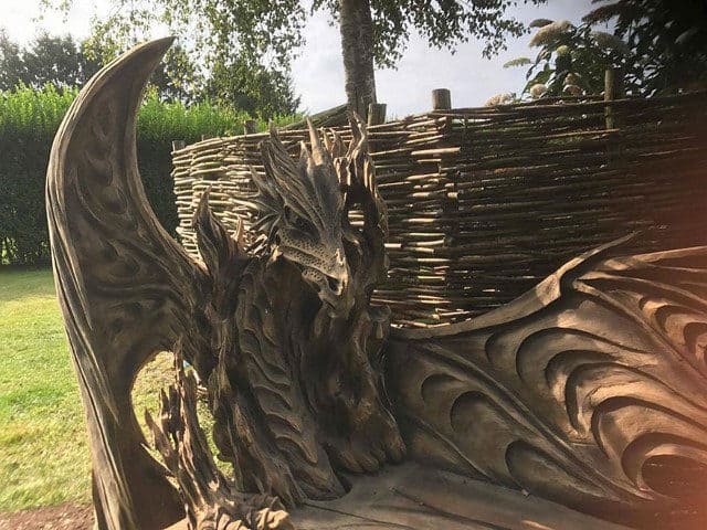 Artist Chainsaw Carves Dragon Bench Out Of Single Piece Of Wood