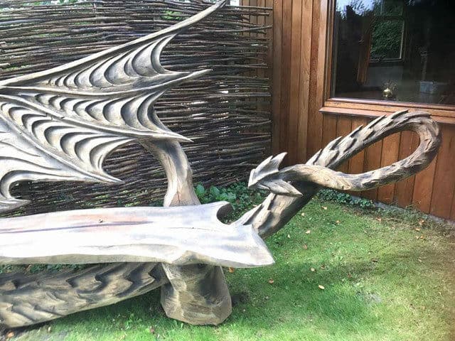 Artist Chainsaw Carves Dragon Bench Out Of Single Piece Of Wood