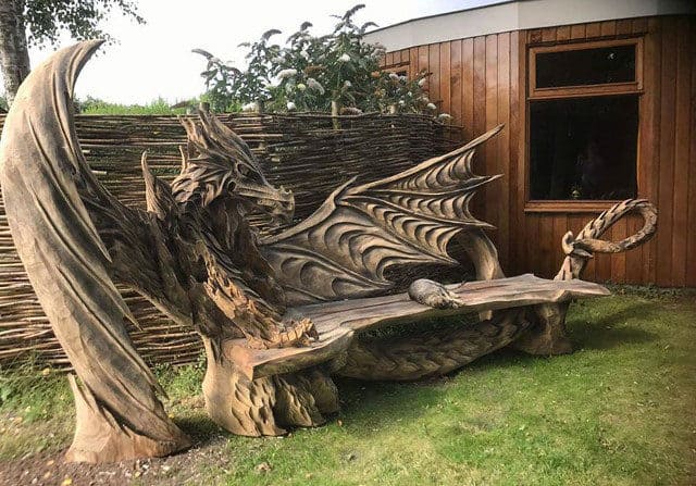 Artist Chainsaw Carves Dragon Bench Out Of Single Piece Of Wood