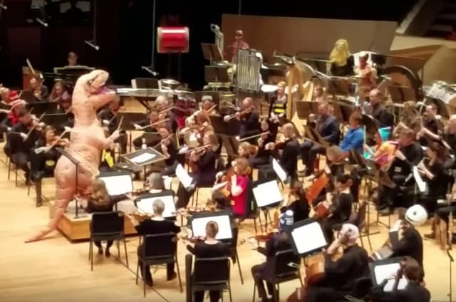 Conductor Sports Dinosaur Costume To Lead Orchestra In Jurassic Park Theme