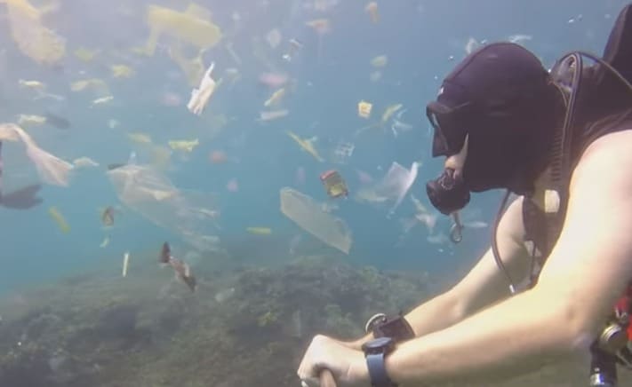 Diver Films Himself Swimming in Sea filled with Plastic Garbage