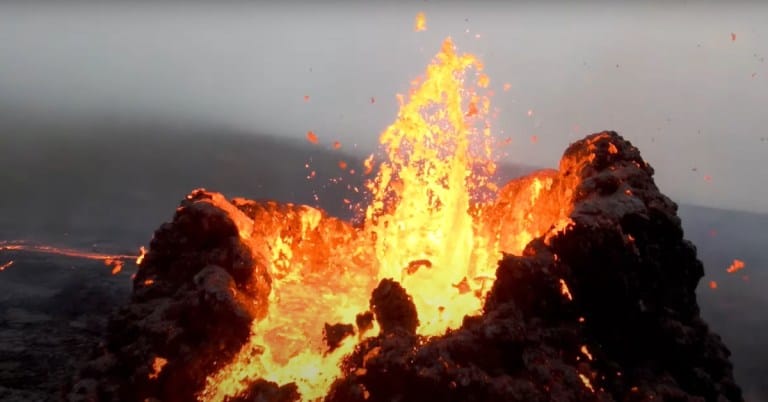 Unreal FPV Footage of a Drone Flying Over and Through a Volcano Eruption