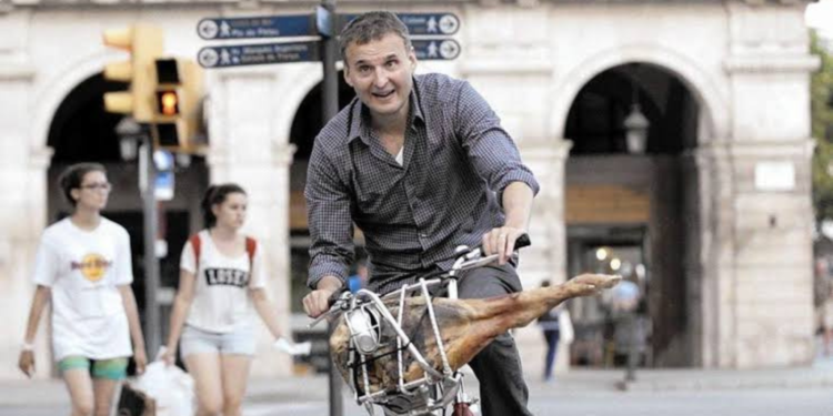 Phil Rosenthal riding a bicycle