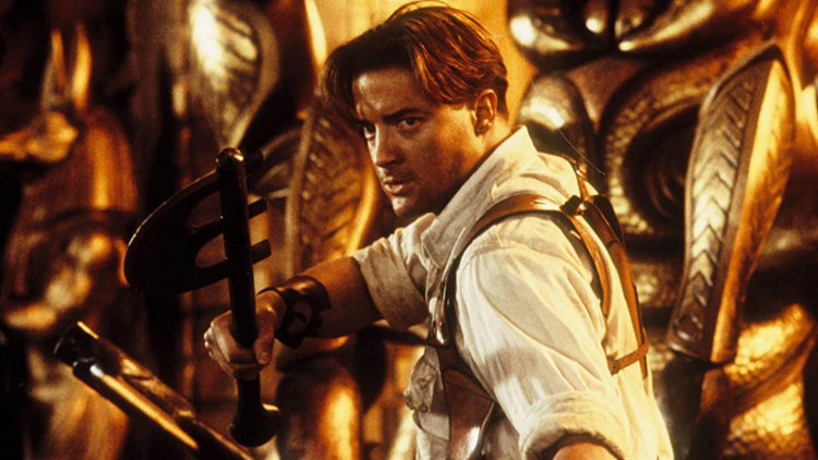 Brendan Fraser holding weapons ready to fight in The Mummy Returns