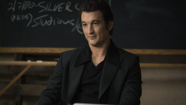 Miles Teller Sat Infront of Chalkboard