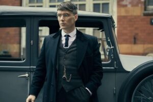 Cillian standing in front of a car