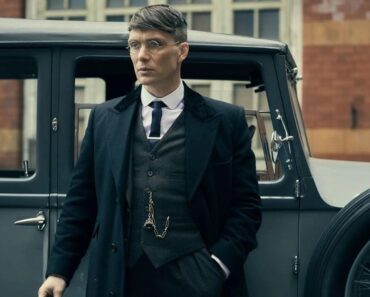 Cillian standing in front of a car