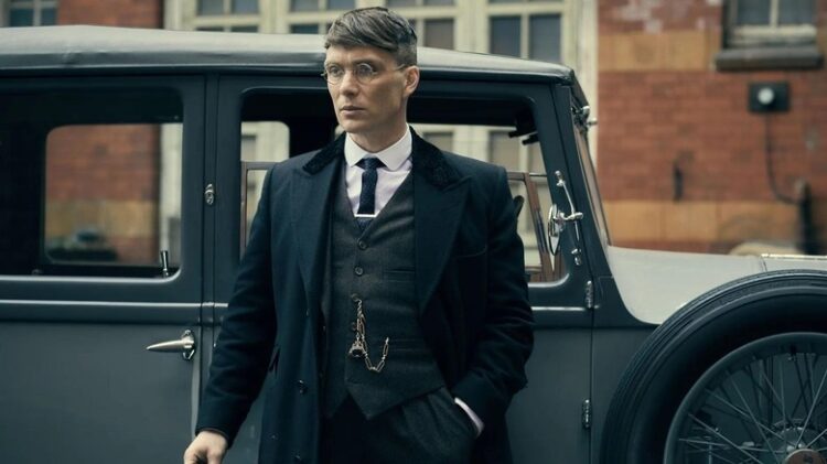 Cillian standing in front of a car