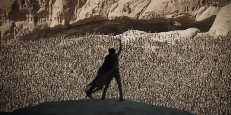 silhouetted man standing in front of an army of desert warriors
