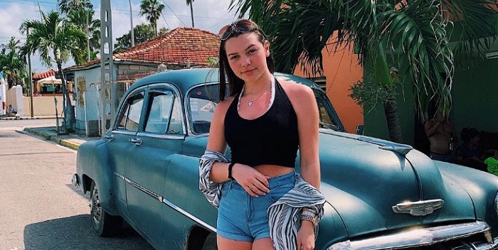 Aaliyah Mendes Standing by a car