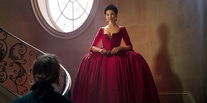 Claire in a form-fitting red dress in Outlander