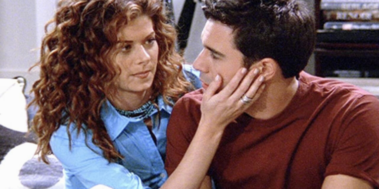 Eric McCormack sitting next to Grace Adler on a couch. 