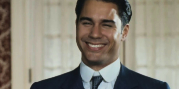 Erick McCormack in a suit and tie smiling.