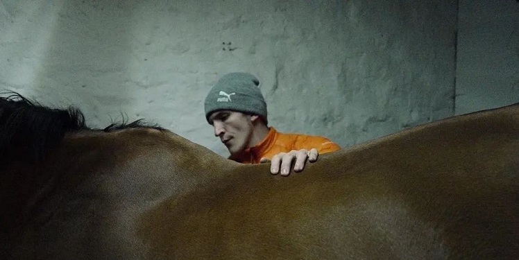 Ewan Mitchell With a Horse in the Short Film Stable