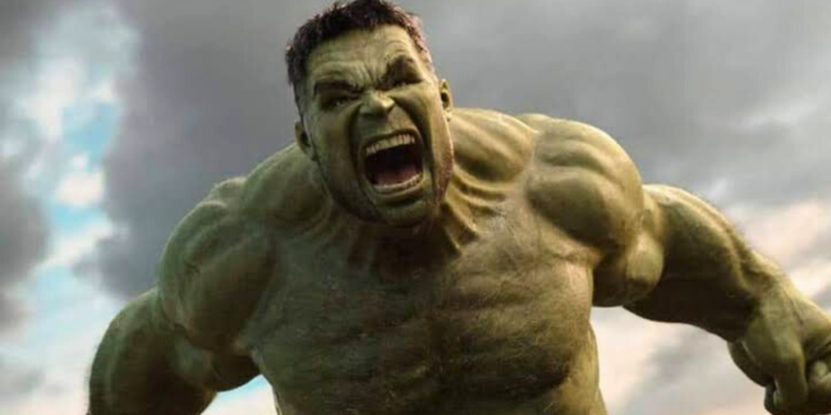 Mark Ruffalo as Hulk with his mouth open standing in front of a cloudy sky.