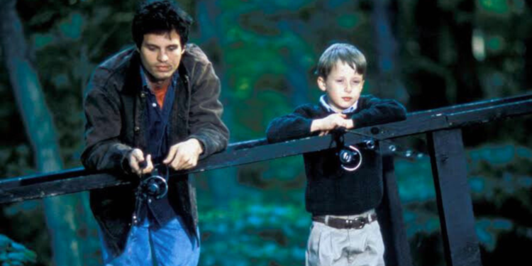 Mark Ruffalo and a boy standing on a bridge.