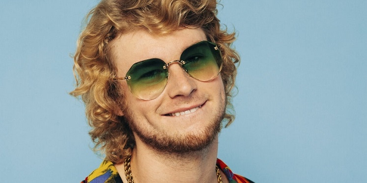 Yung Gravy wearing sunglasses and biting his lip