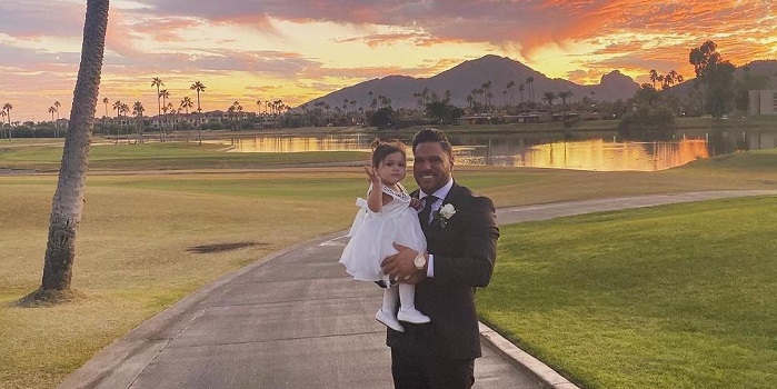 Ariana and her father posing for the camera