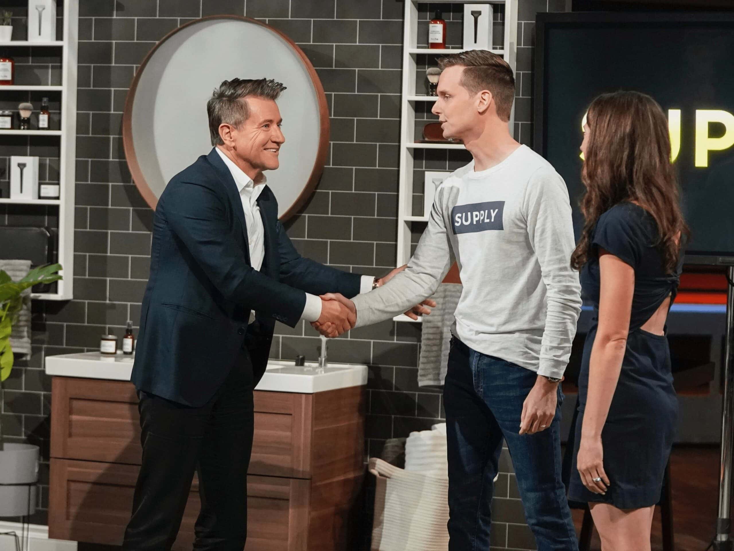 Black Paper Party handshake with Shark 5 Reasons Black Paper Party Thrived on Shark Tank