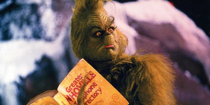 Grinch reading a book