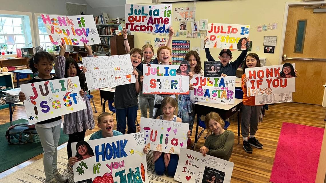 Classmates holding Honk if you love Julia signs