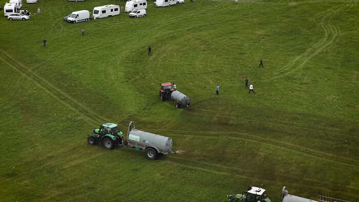 Photographer Reveals The Full Story After Farmer Goes Viral For Spraying Squatters With Manure