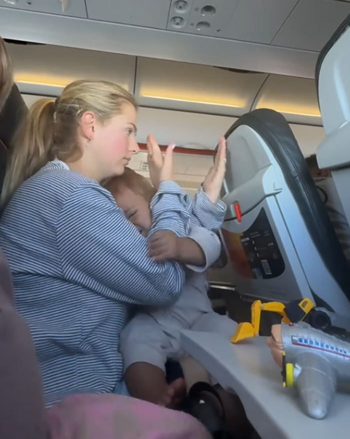“Buy Another Seat”: Mom Sparks Outrage After Passenger Reclines Seat Into Her Lap