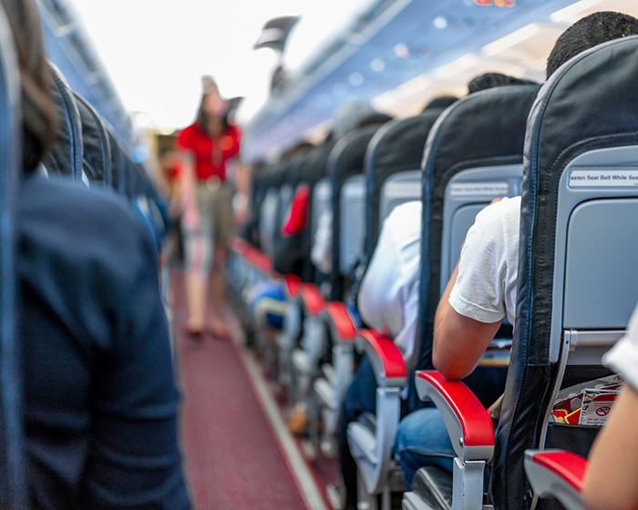 “Buy Another Seat”: Mom Sparks Outrage After Passenger Reclines Seat Into Her Lap