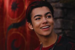 malachi barton smiling red background