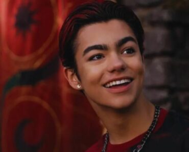 malachi barton smiling red background
