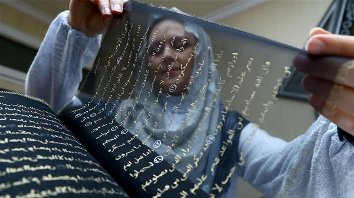 Artist Spends 3 Years Rewriting The Entire Quran In Gold On 164 Feet Of Silk By Hand