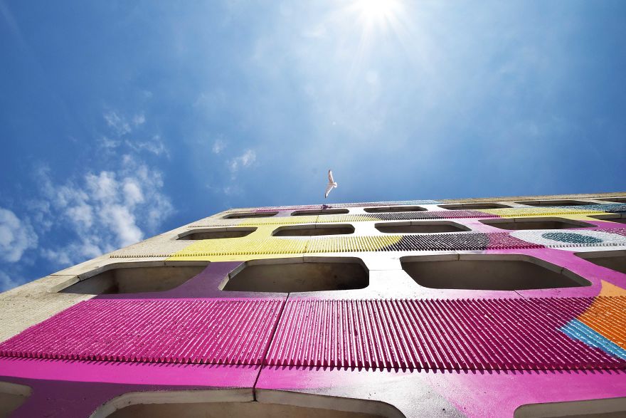 Street Artist Transforms 60s Carpark With Giant, Candy-Striped Supergraphic Artwork Street Artist Transforms 60s Carpark With Giant, Candy-Striped Supergraphic Artwork
