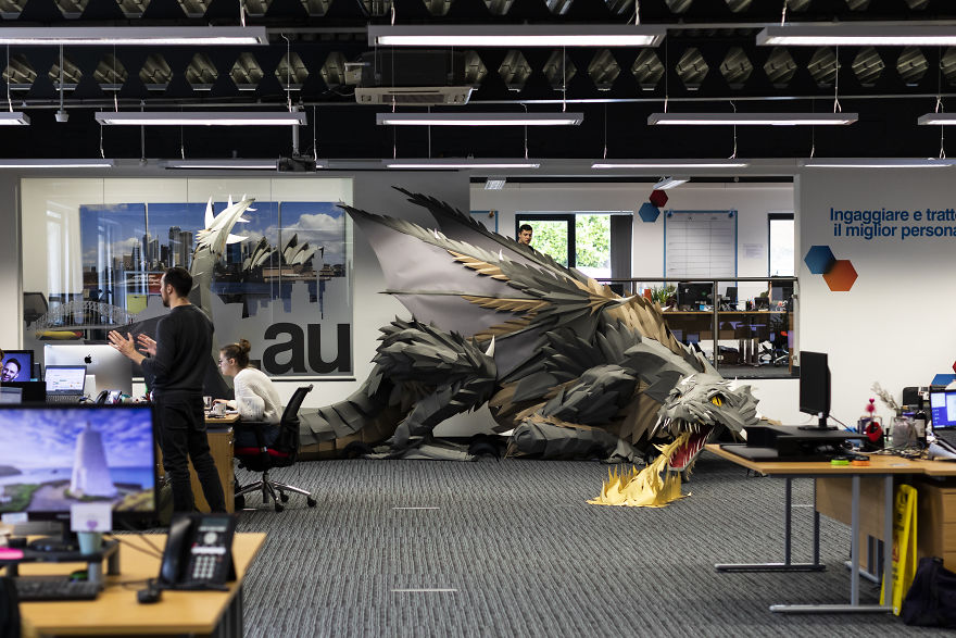 On Monday Morning, We Arrived At Work To Find A Fire-Breathing Dragon Built With 1200 Paper Sheets
