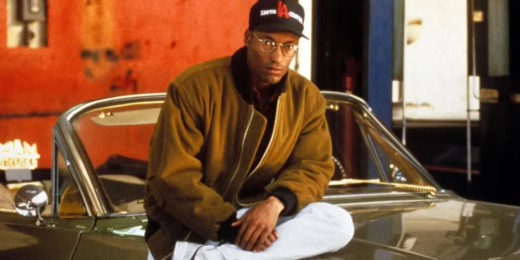 John Singleton on a car hood 