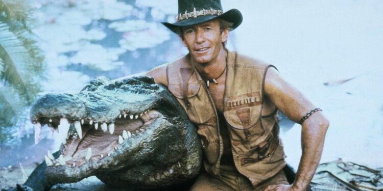 Paul Hogan holding a crocodile by the neck
