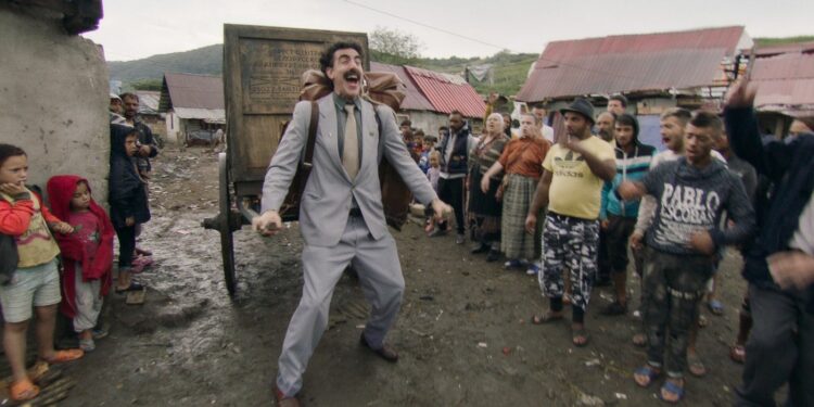 a man in suit dragging a cart