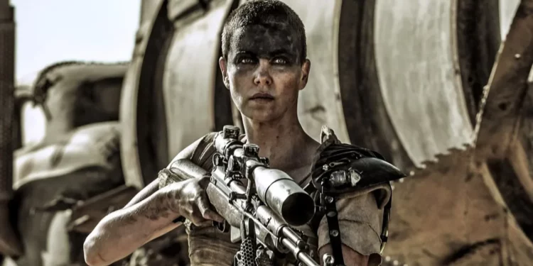 Charlize Theron holding a gun 