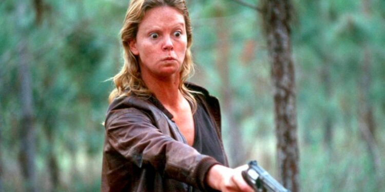 charlyze theron with a revolver poaing in a film charlyze theron with a revolver poaing in a film