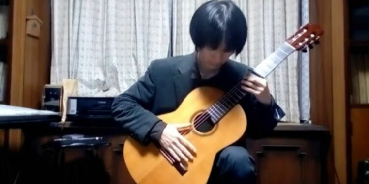 Hiroki Doi with a guitar