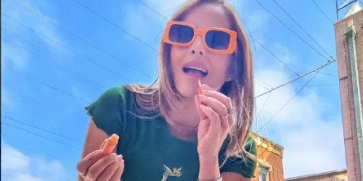 Amy Paffrath applying lipstick