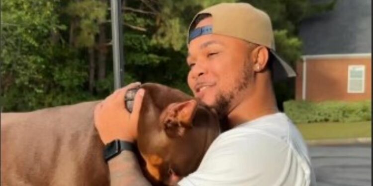 Suave Xavier petting his dog