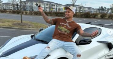 Suave Xavier posing on his luxury car