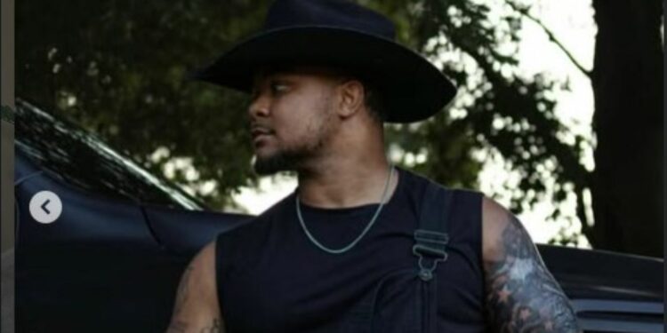 Suave Xavier in front of his car