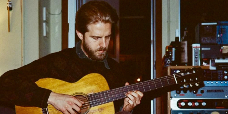 Christian Lee Hutson playing the guitar