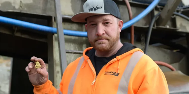 Rick Ness holding a gold nugget
