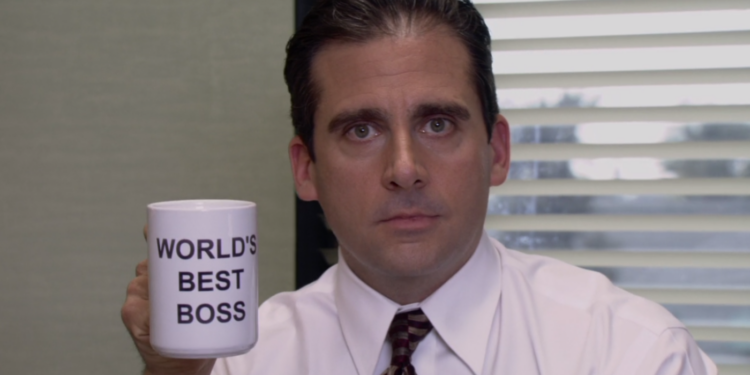 A scene from The Office where character named michael scott holding a mug A scene from The Office where character named michael scott holding a mug