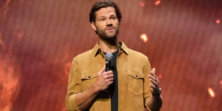 Jared Padalecki hoding a mic