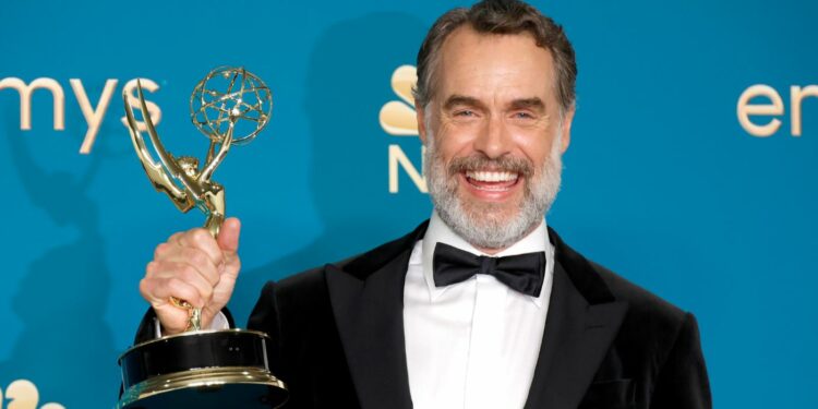 Murray Bartlett holding emmy award